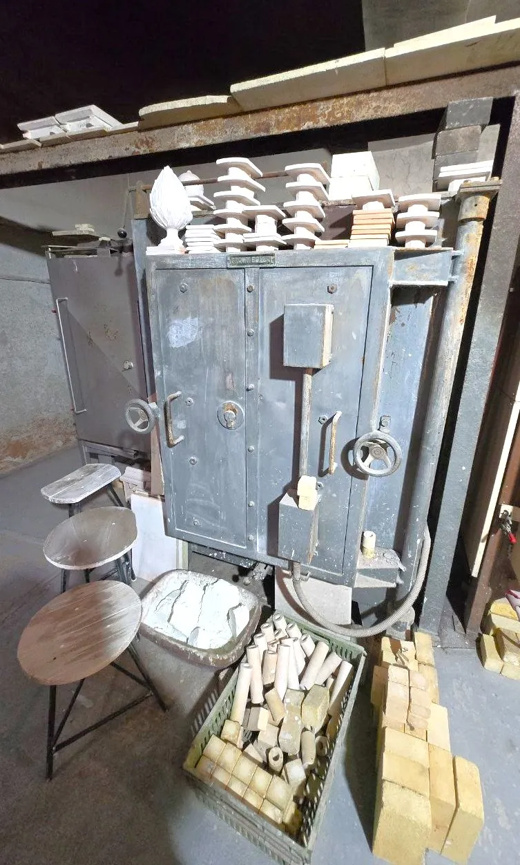A Kiln Surrounded by Raw Tiles and Fireclay Bricks