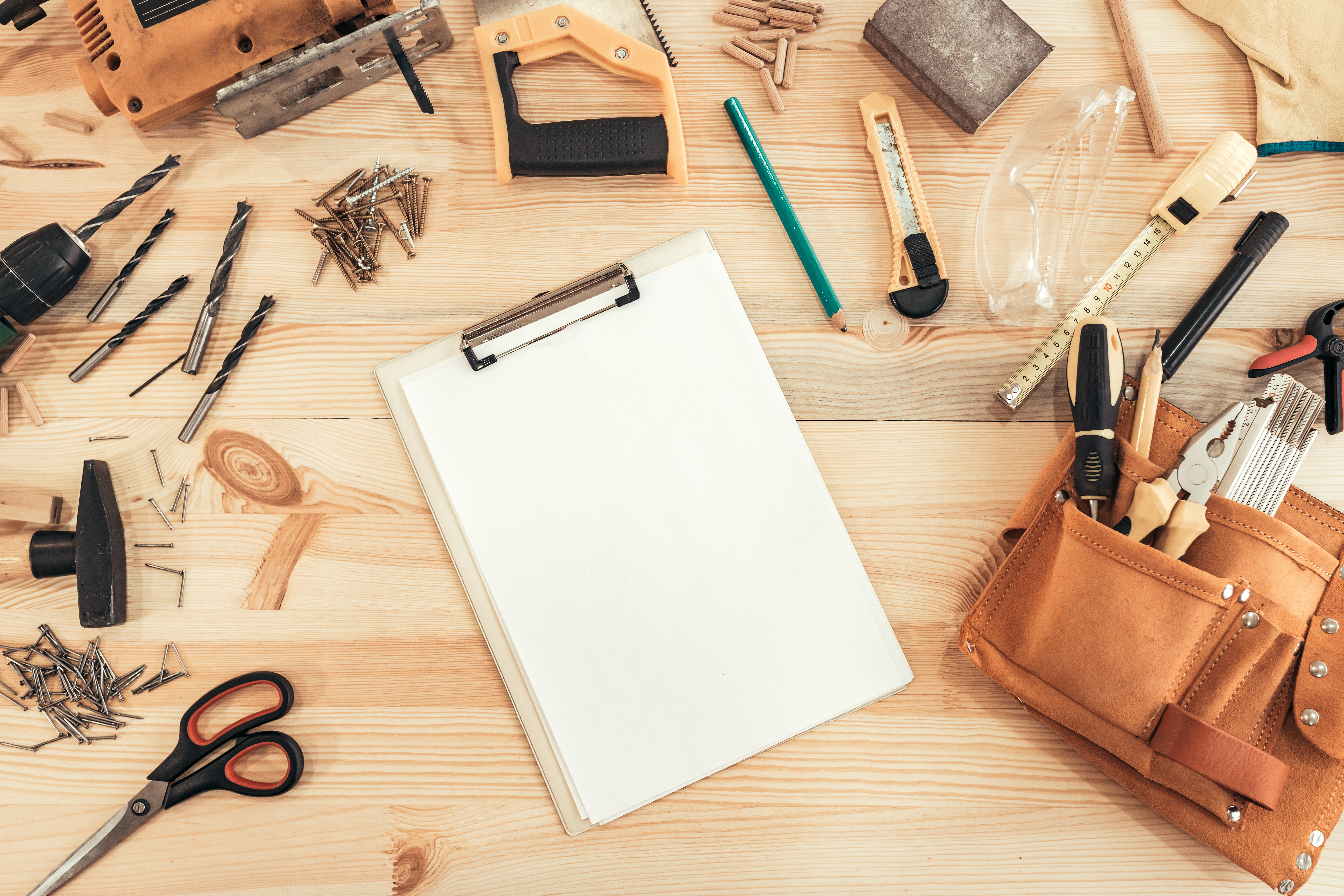 Clipboard on a workbench with tools.