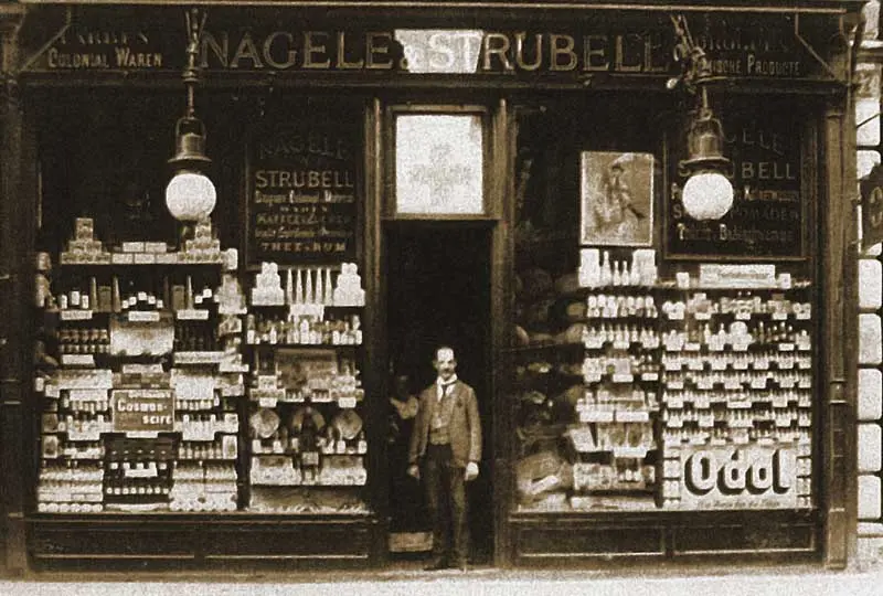 Image Credit: Nägele & Strubell Historic storefront of Nägele & Strubell at Graben 27 in Vienna, showing perfumery and drugstore goods displayed in the windows.