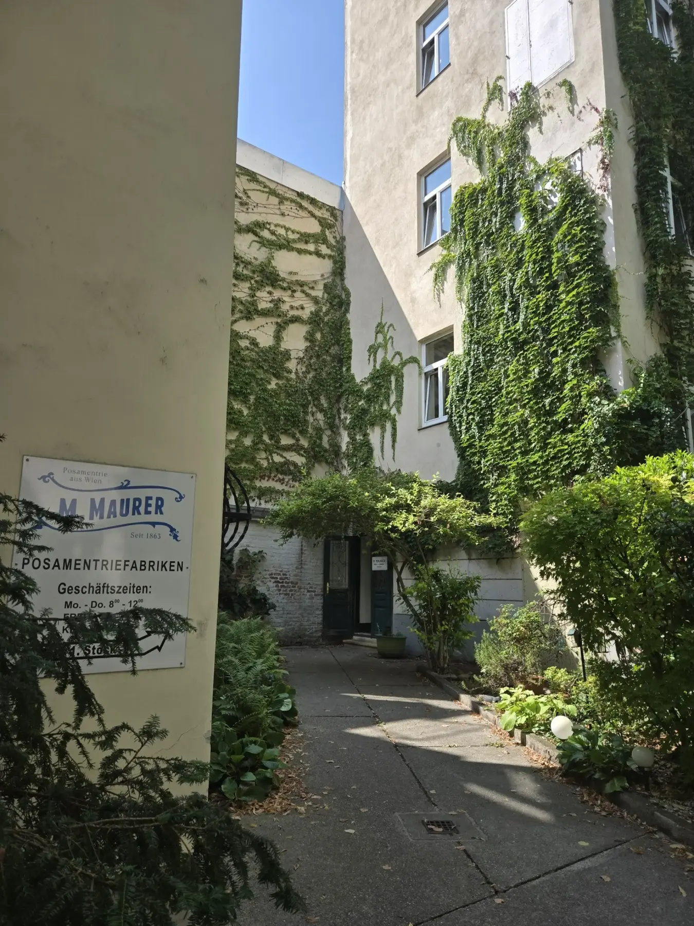 Image Credit: Bespoke Vienna Entrance to M. MAURER’s passementerie manufactory in a green Vienna courtyard.