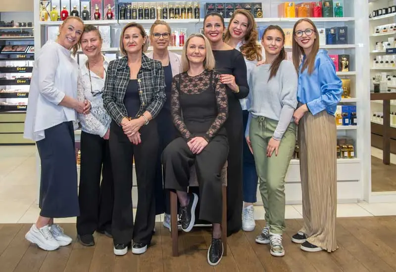 Image Credit: Nägele & Strubell Nägele & Strubell team members standing together inside the Graben perfumery in Vienna.
