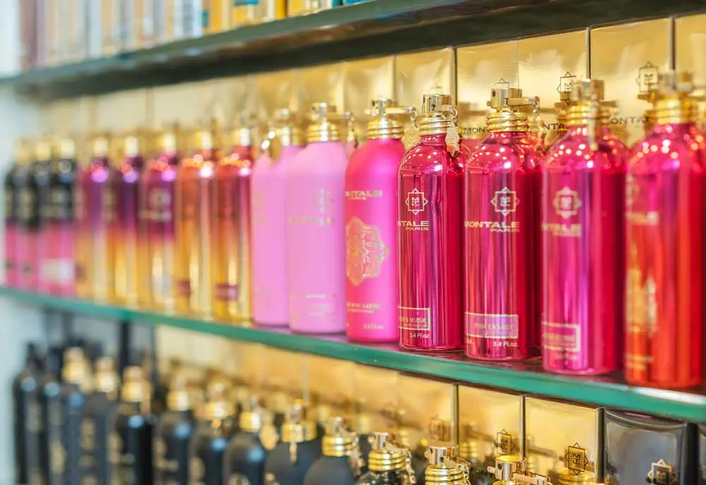 Image Credit: Nägele & Strubell Rows of colourful lotion bottles displayed on glass shelves inside Nägele & Strubell.
