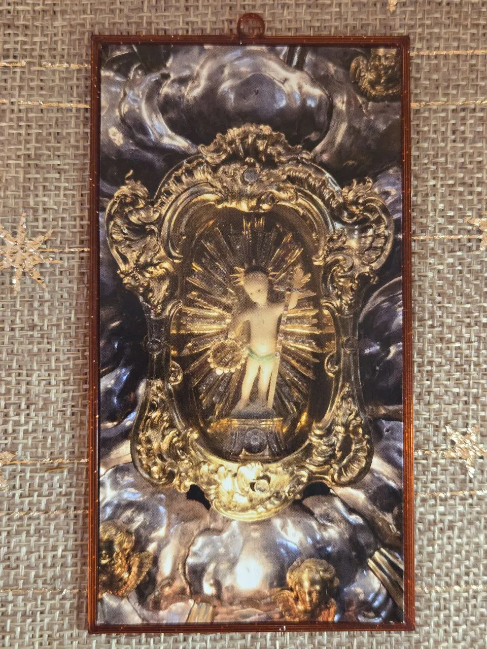 A 17th-century wax Christ child devotional image housed in a simple, modern 3D-printed frame