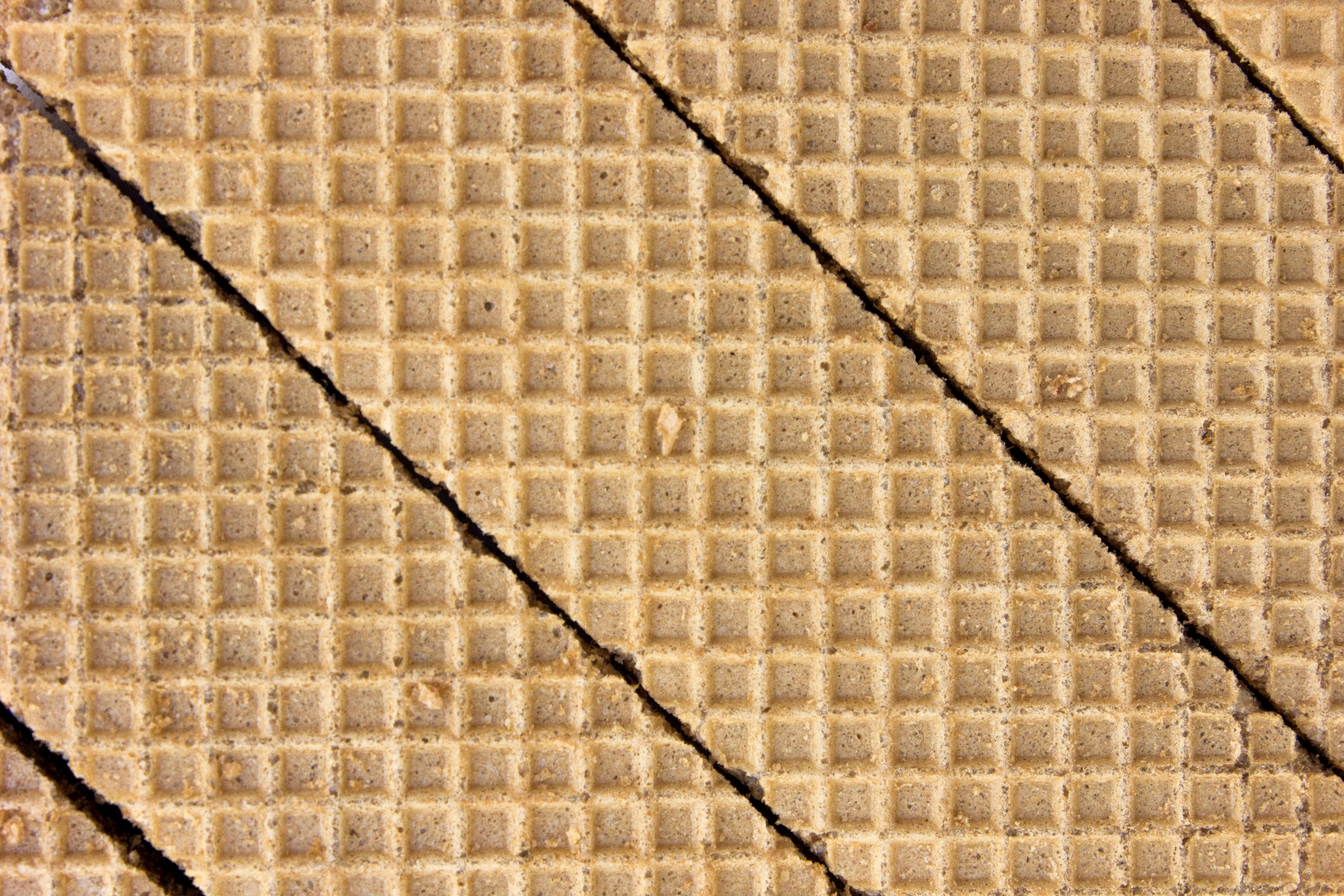 Close-up of a wafer sheet with diagonal break lines cutting across the grid surface.